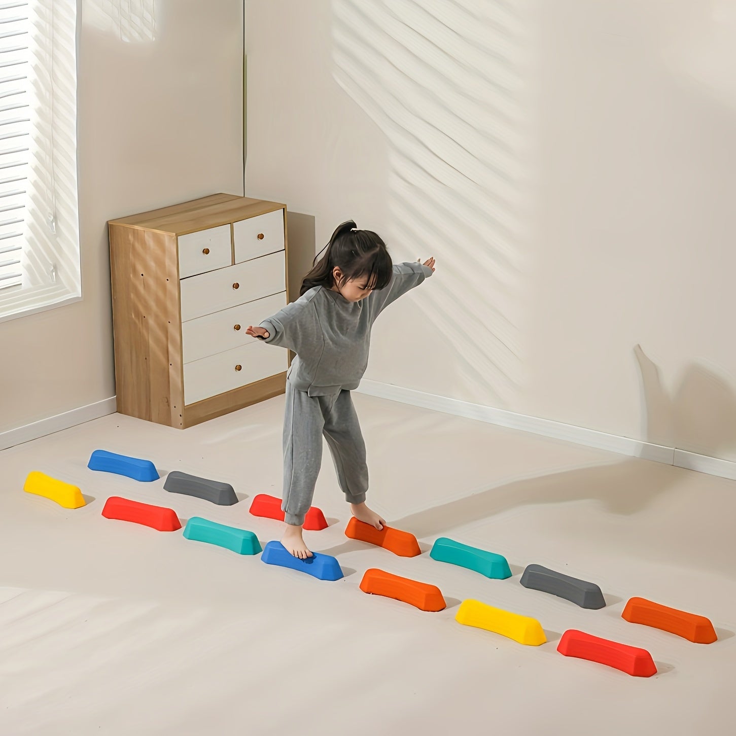 Child balancing on sensory stepping stone toy